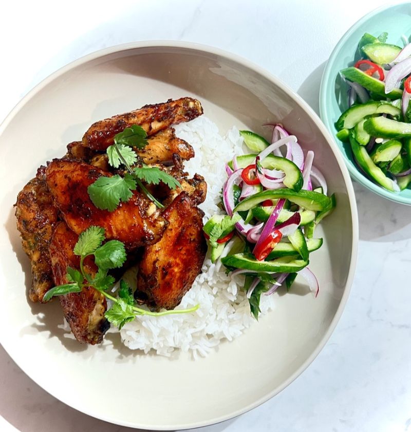 CORINADER AND HOISIN CHICKEN WINGS in a bowl with rice