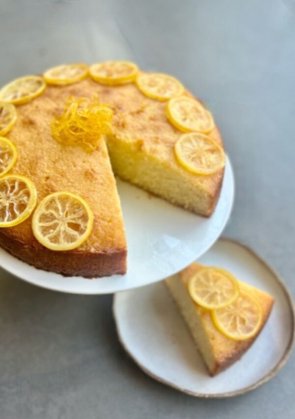 Coconut & Lemon Syrup Cake with wedge cut out
