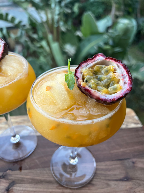 cocktail with passionfruit half on top