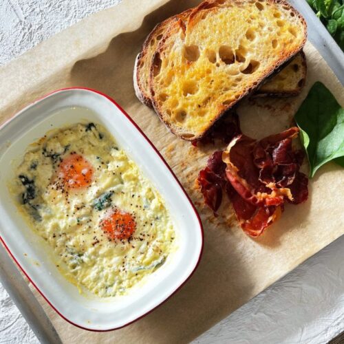 baked eggs with toast and proscuitto