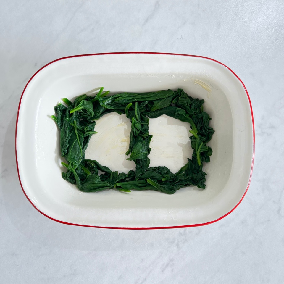 ramkein on white background with spinach in a figure 8 