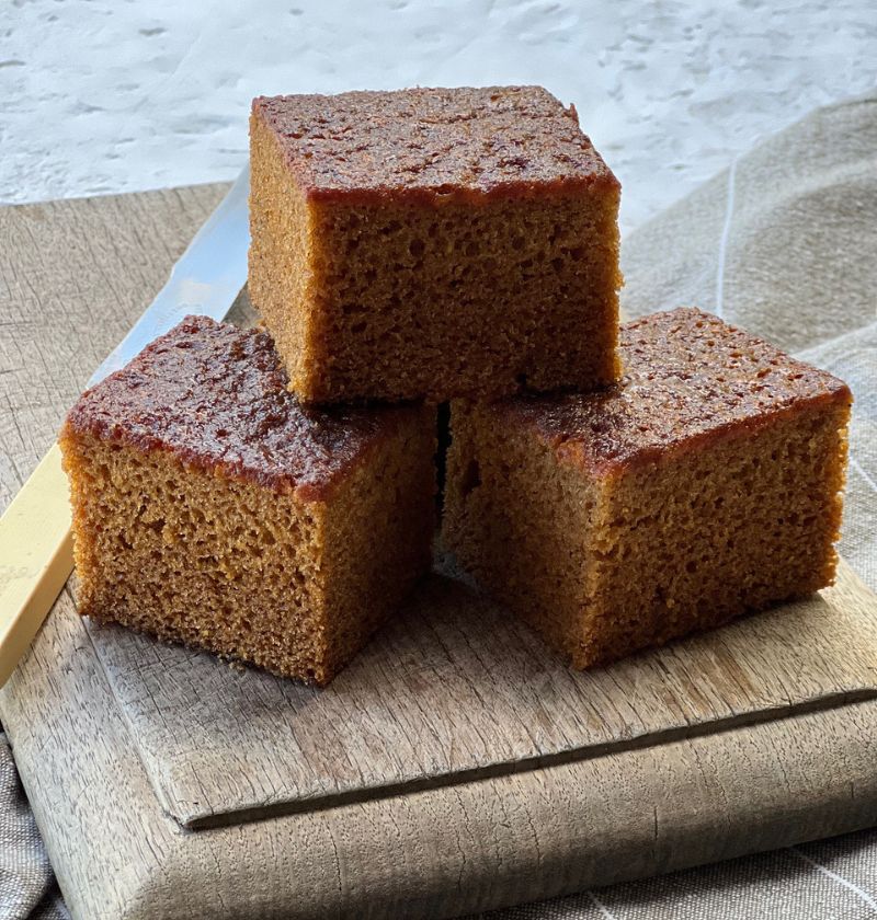 cake squares on wooden board with bone handle knife