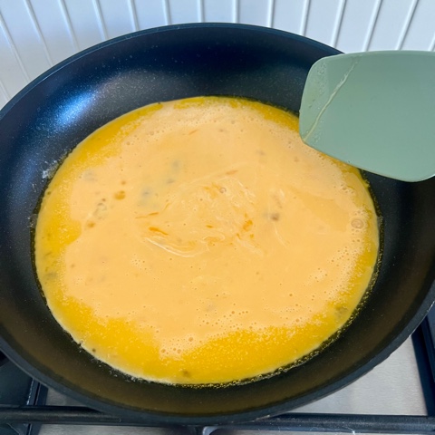 scrambled egg mixture poured in a pan