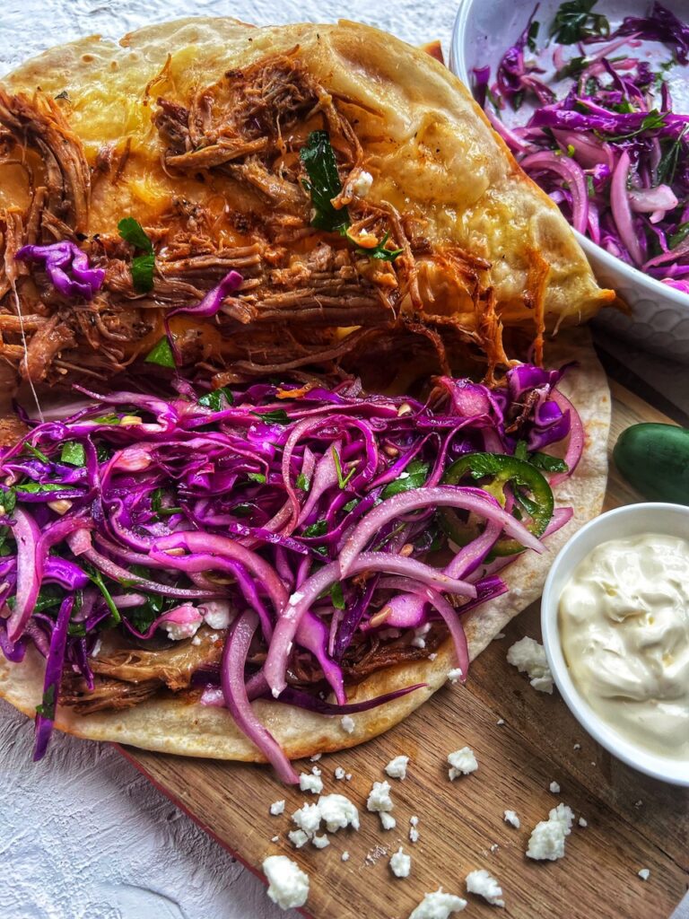 Pulled pork quesadilla with on a wooden board 