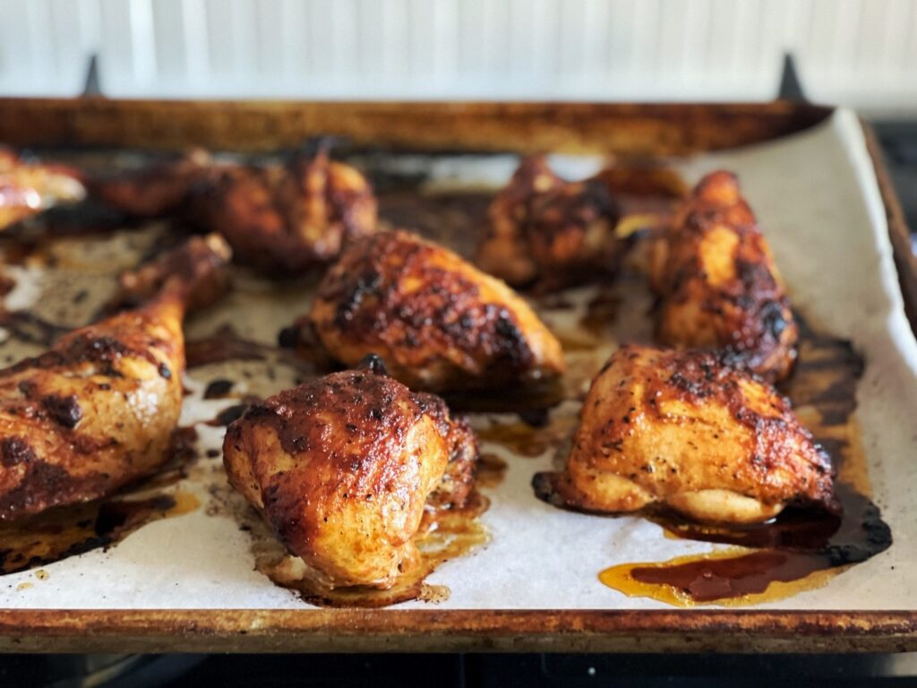 Roast Peruvian Chicken pieces on a baking tray