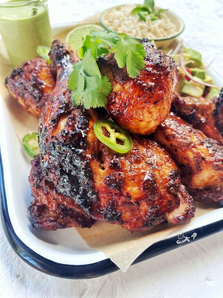 close up of Peruvian roast chicken pieces on a tray