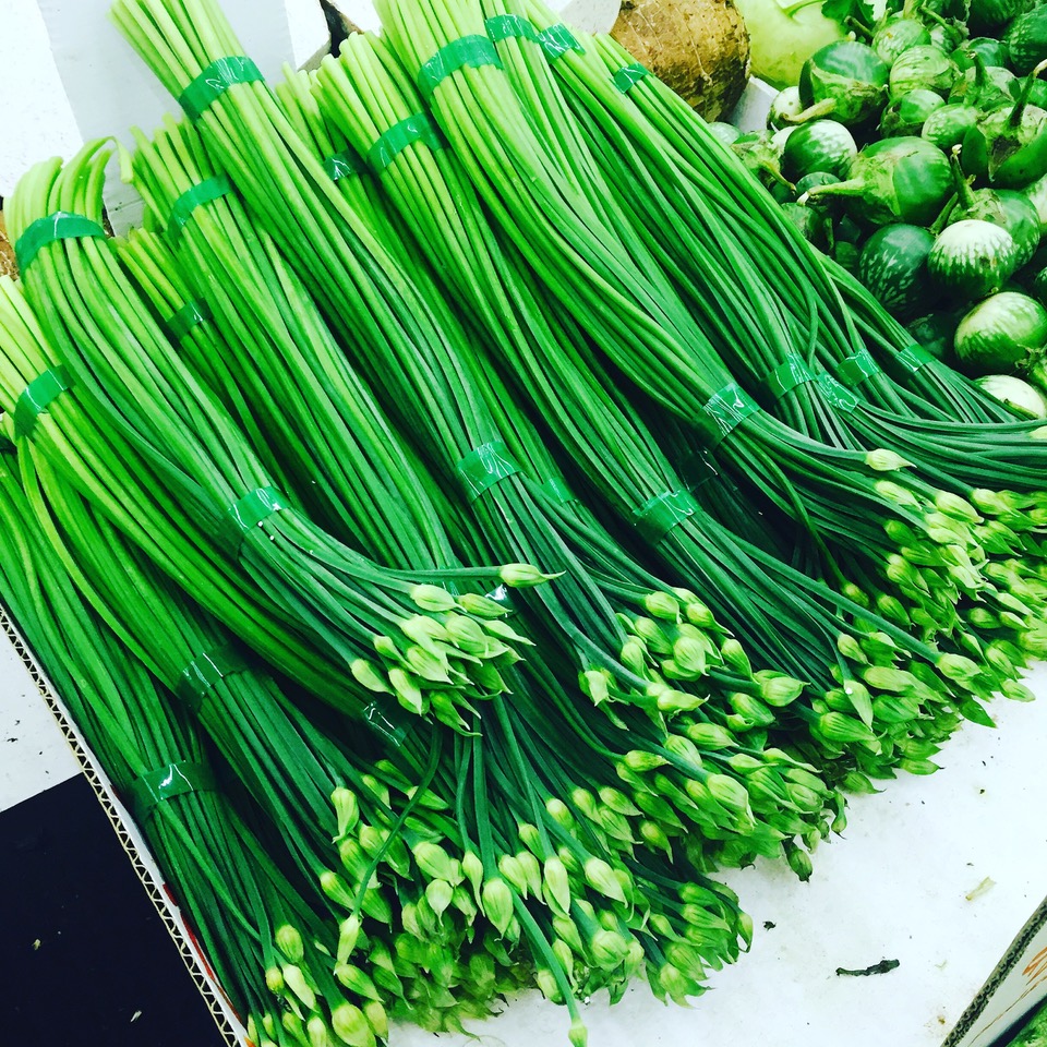 Garlic chives bunches for sale on a table