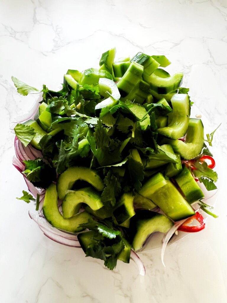 cucumber and coriander, red onion and chilli  in glass bowl