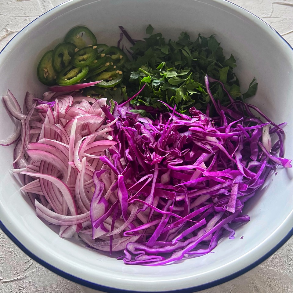 slaw ingredients in a bowl ready to be tossed