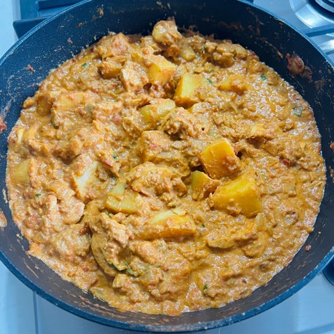 Indian chicken curry with potatoes in a pan cooked