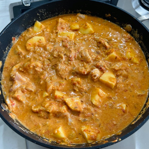Indian Chicken curry cooking in  pan