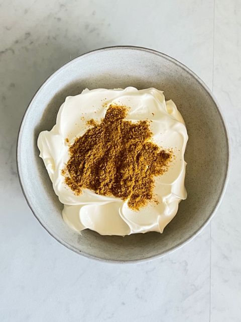 sour cream in a bowl with curry powder