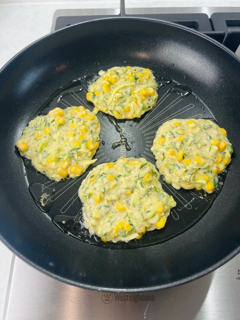 fritter batter cooking in a pan