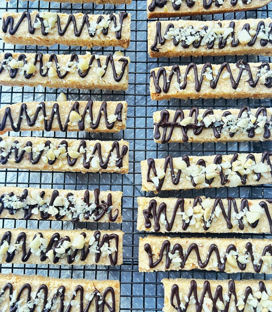 shortbread fingers on a wire tray with chocolate drizzled over