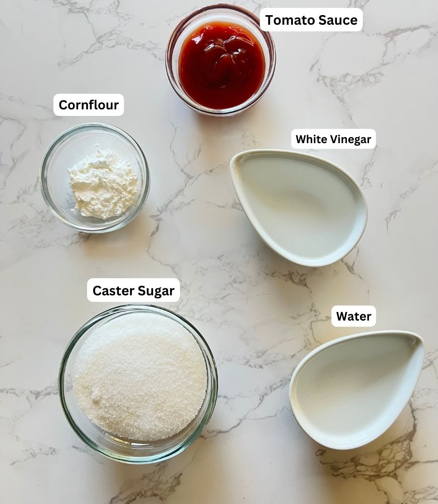 ingredients laid out on white marble board.
Cornflour, Tomato sauce, white vinegar, water and sugar