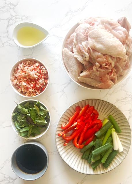 Thai basil chicken wing ingredients on white marble background
