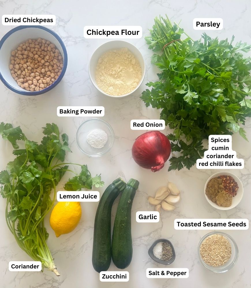 Zucchini & Sesame Falafel Ingredients board. Chickpeas, chickpea flour, parsley, coriander, red onion, baking powder, spices, garlic, zucchini, sesame seeds, lemon juice and salt and pepper