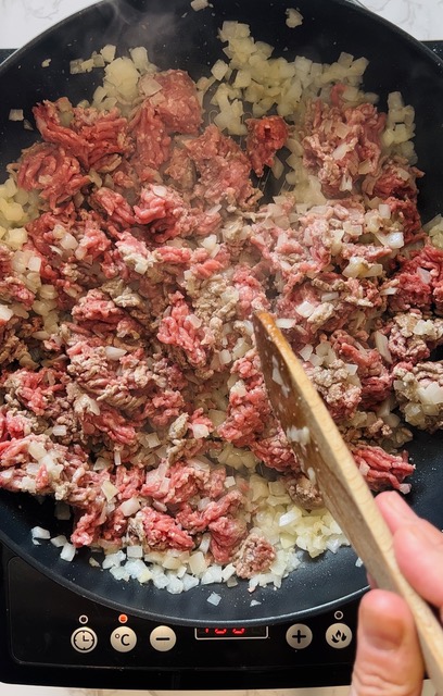 breaking up beef mince in frying pan