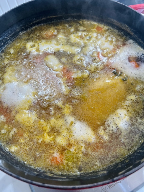 cooked chicken breast in stock in large pot