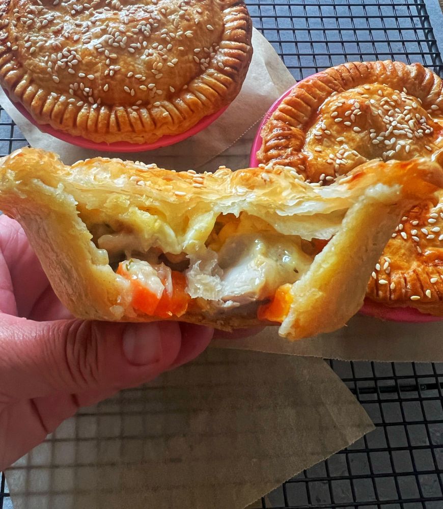 chicken pie with bites out of it to reveal filling