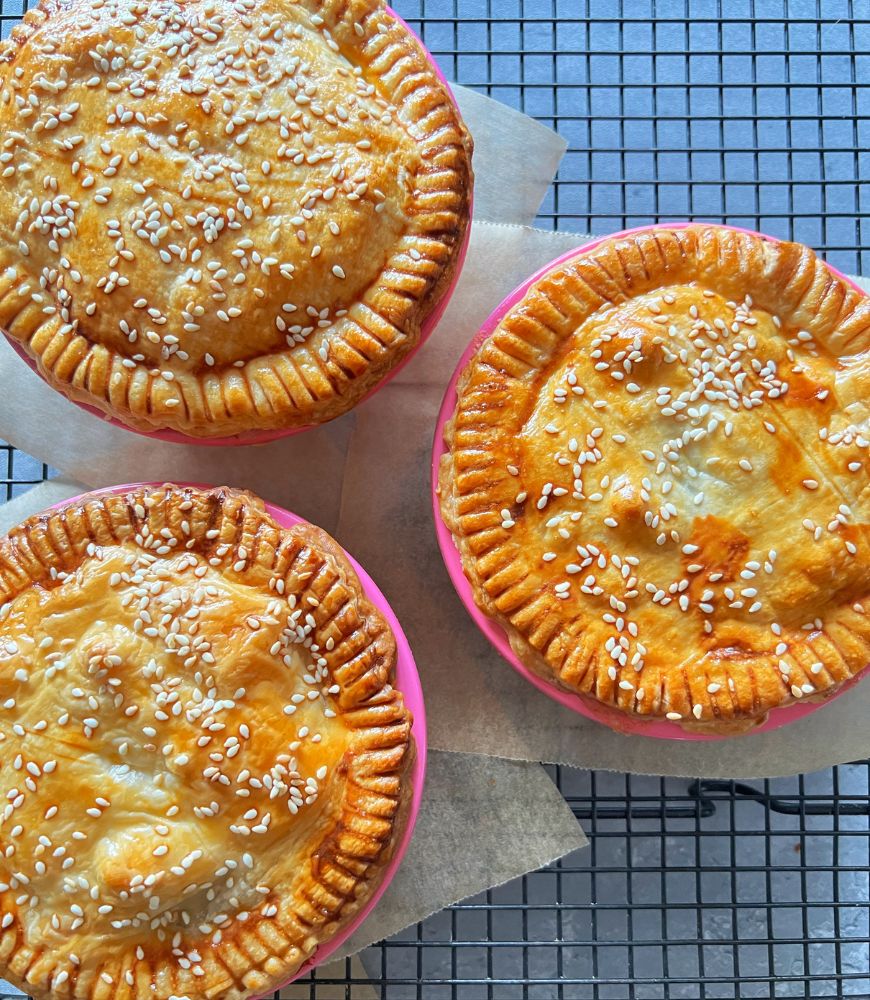 3 chicken & camembert pies sitting on a wire rack