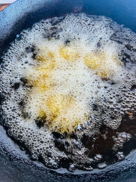 deep frying falafels in a wok of hot oil