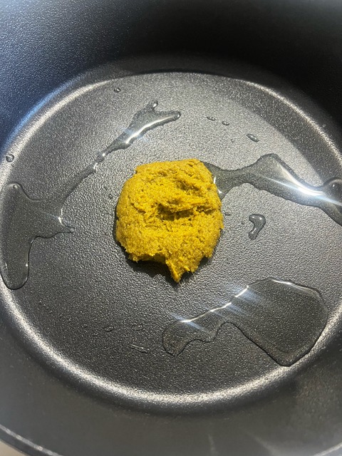 green curry paste and oil in a pan