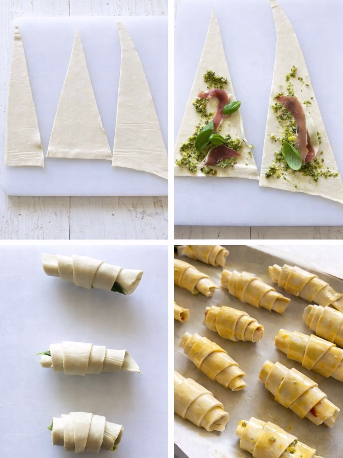 Step by step process showing puff pastry triangles, pesto and prosciutto filling, rolled croissants, and unbaked croissants on a tray on a white timber surface.