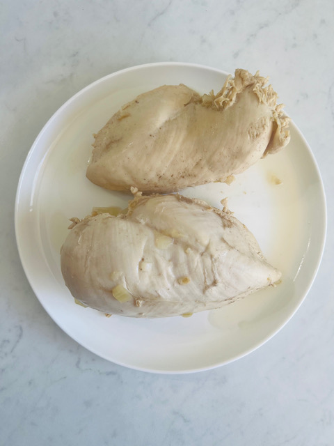 poached chicken breasts on white plate