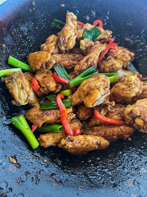 Thai basil wings cooking in wok