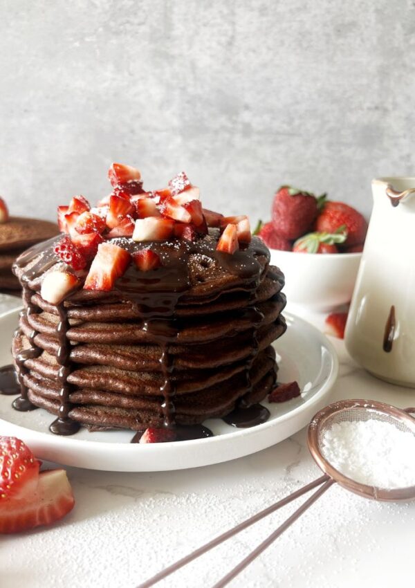 chocolate pancake stack on white plate