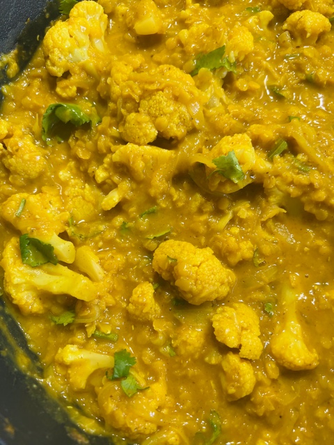 Red Lentil, cauliflower & coconut curry cooking in a pan