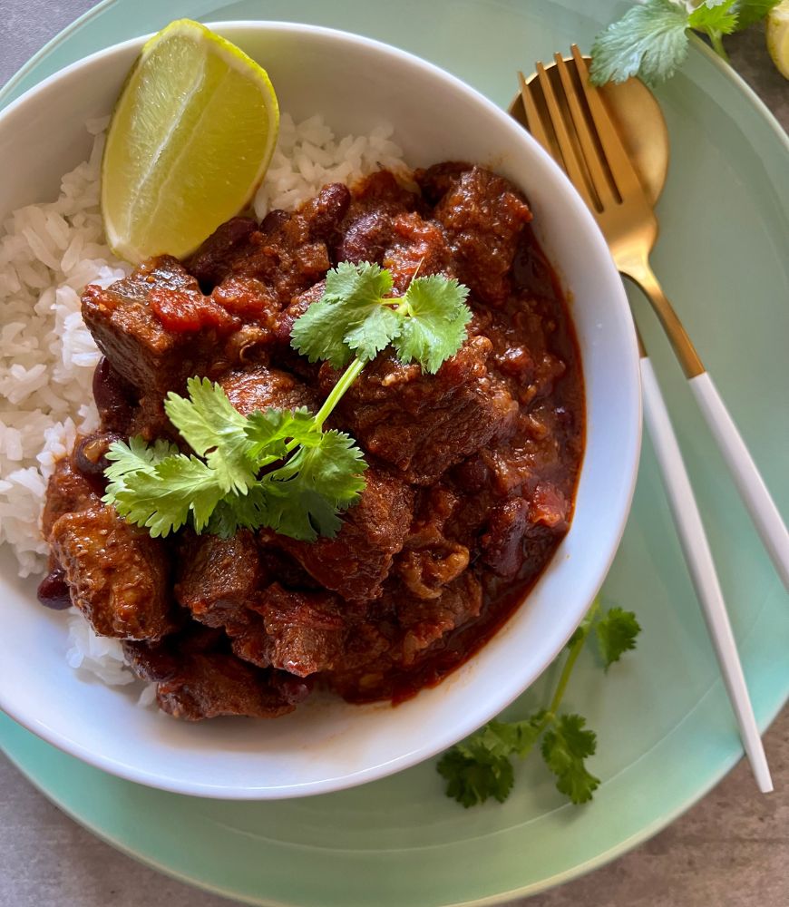 Mexican Chilli Beef in white bowl with lime cheek