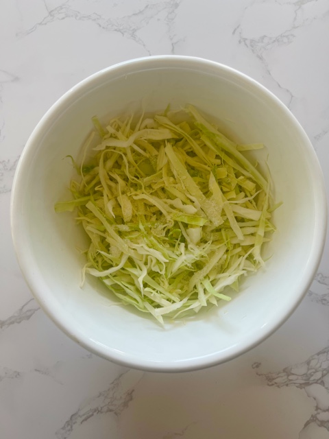 cabbage in salt in a white bowl