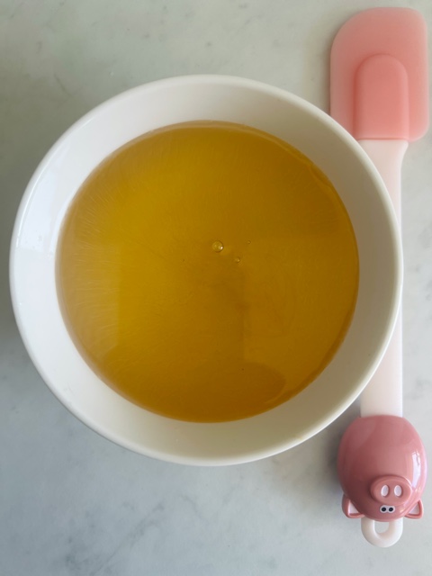 syrup in white bowl with fish sauce added with pink spatula