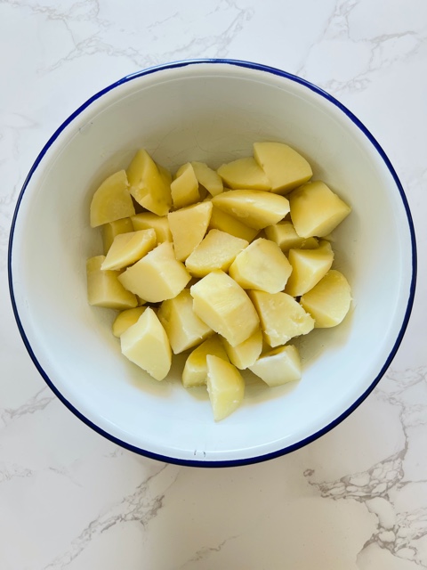 potato cubes in a white bowl