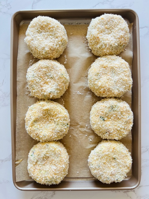 crumbed salmon potato cakes on a baking tray with baking paper