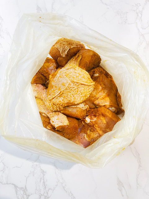 chicken and curry powder in a bag