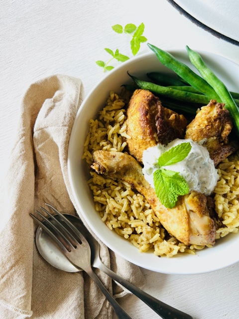 Chicken and rice in a bowl on white background