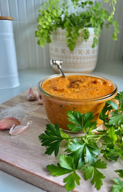 Romesco Sauce on a board with parsely and garlic