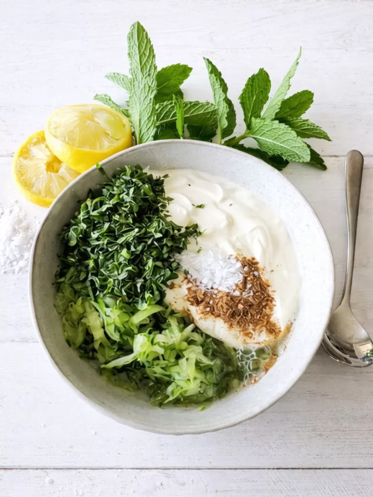 cucumber yoghurts ingredients in a white bowl.