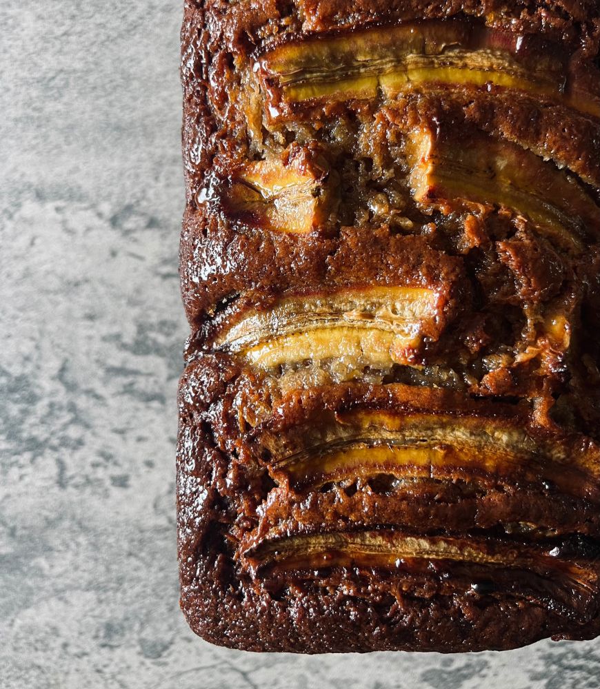 close up image of banana bread on marble background