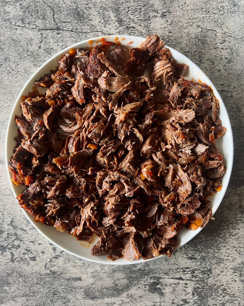 shredded beef shin on a white plate