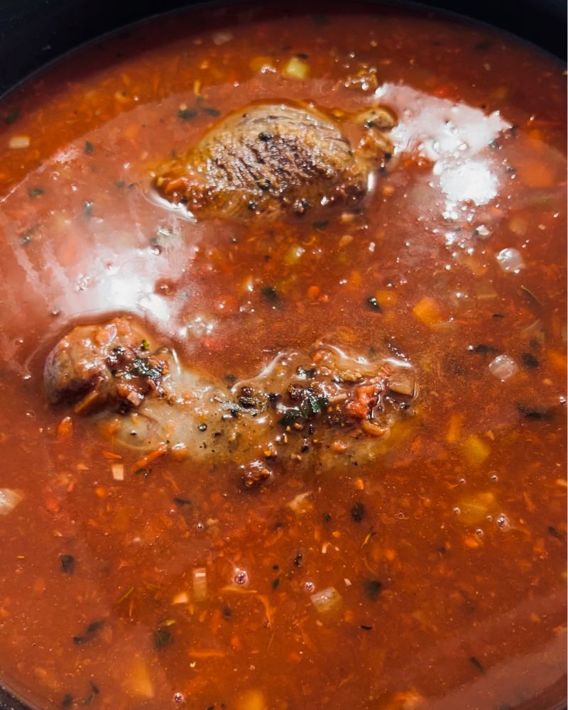 beef stewing in a pot