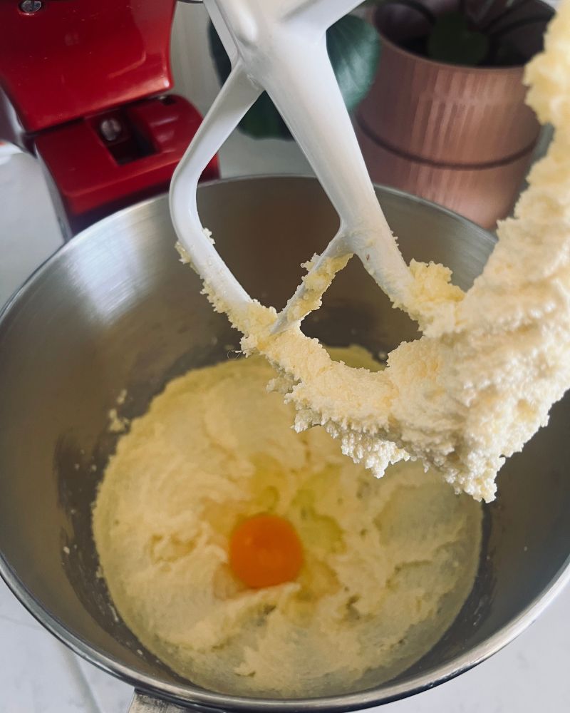 adding egg to butte and sugar in a bowl