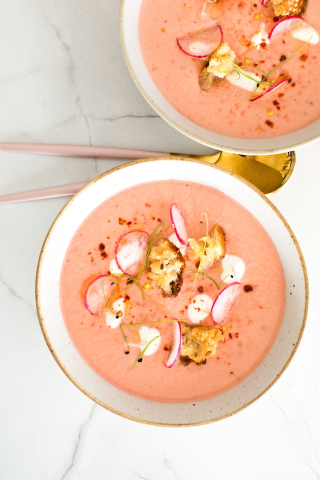 2 bowls of watermelon soup on white background
