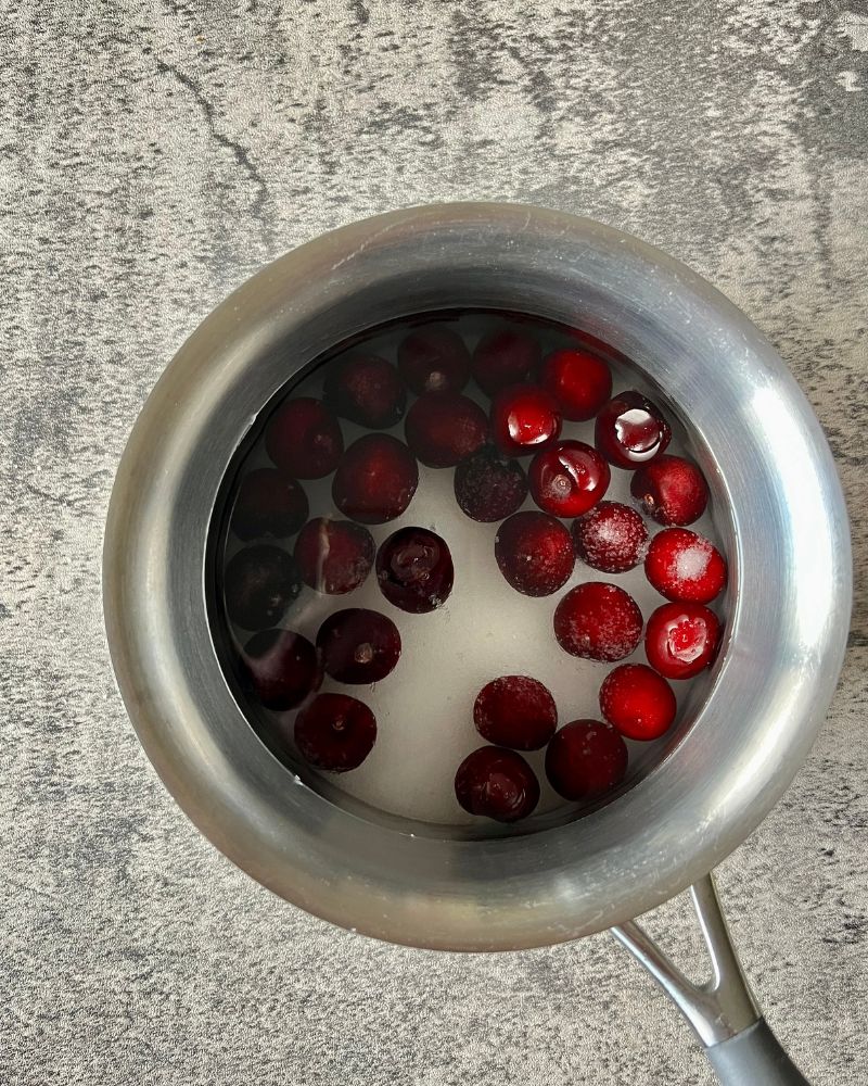cherries, water and sugar in a sacuepan