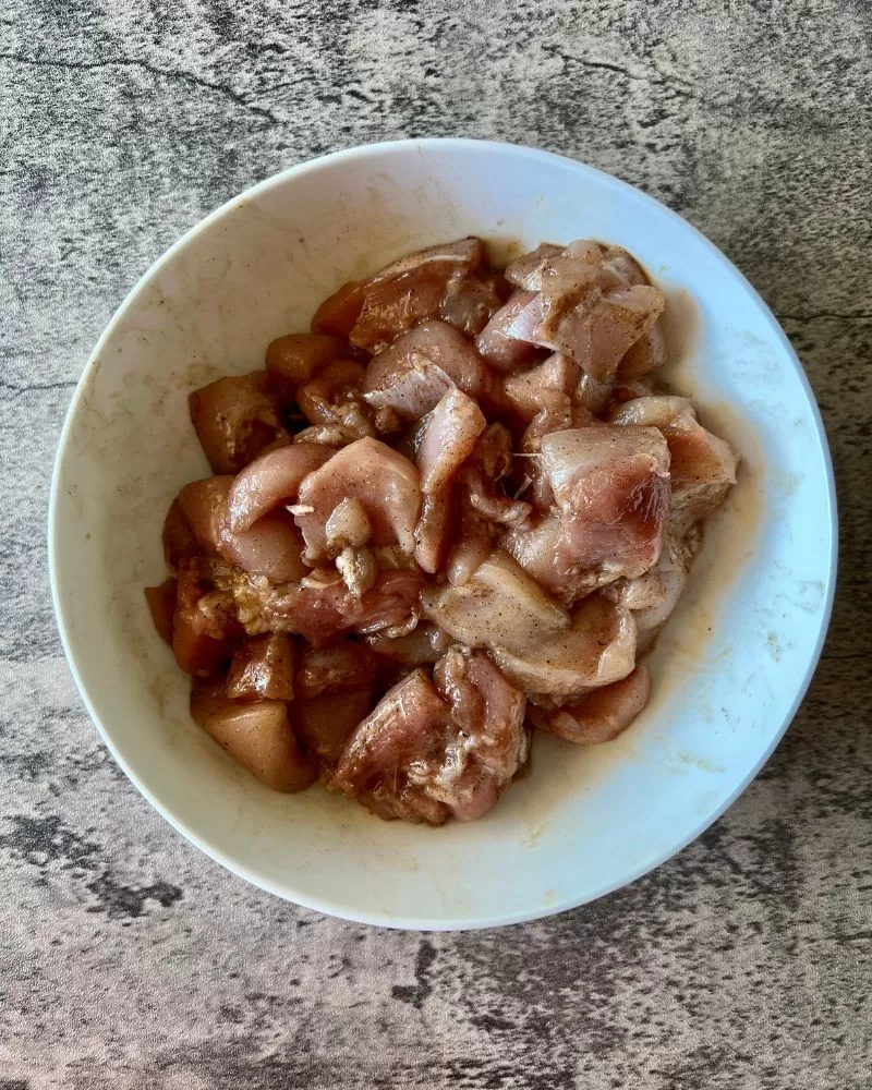 marinated raw pork in white bowl on marble background