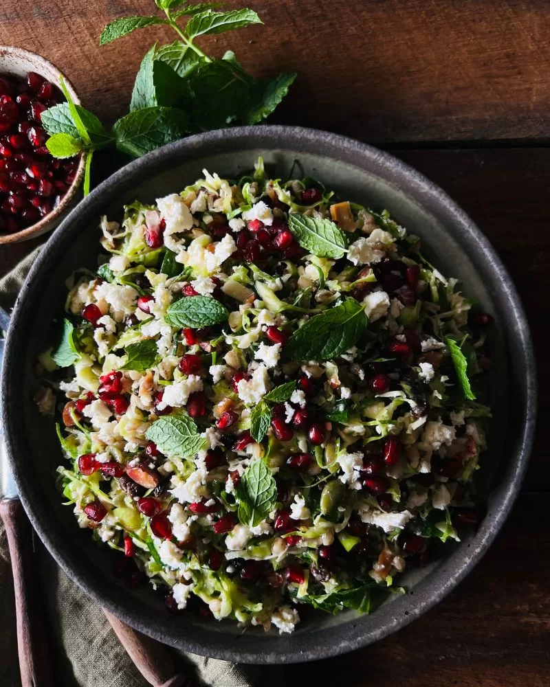 salad topped with feta and pomegranate perils