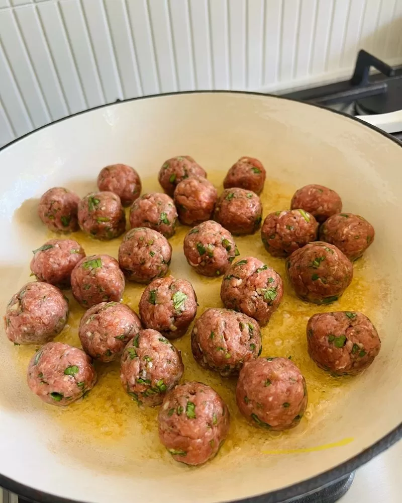 meatballs cooking in pan